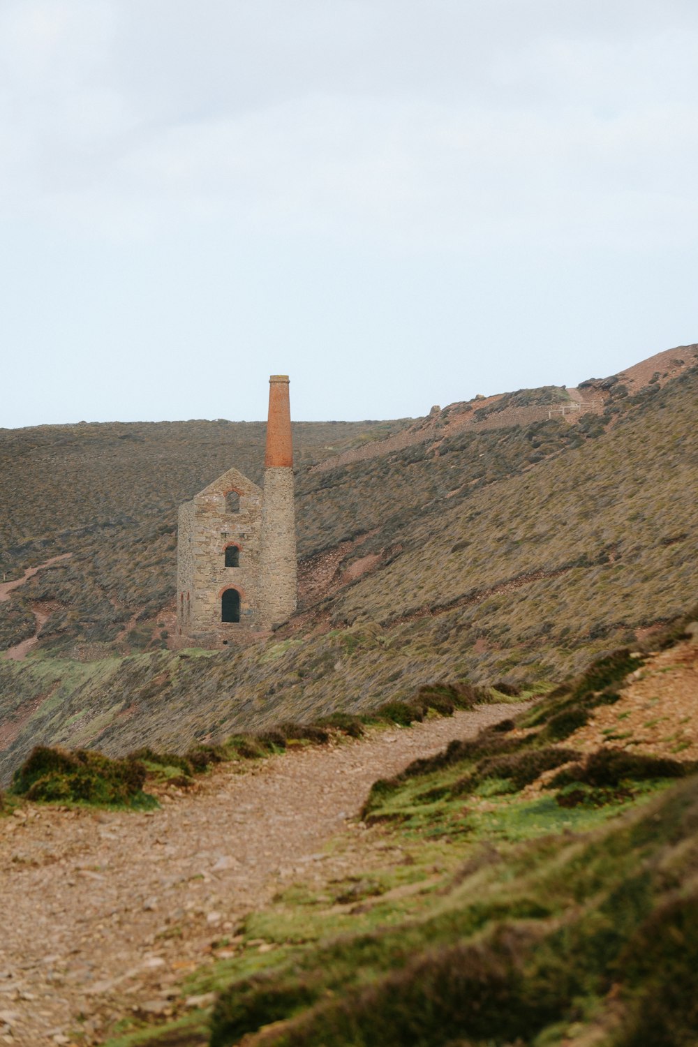 a stone building sitting on the side of a hill