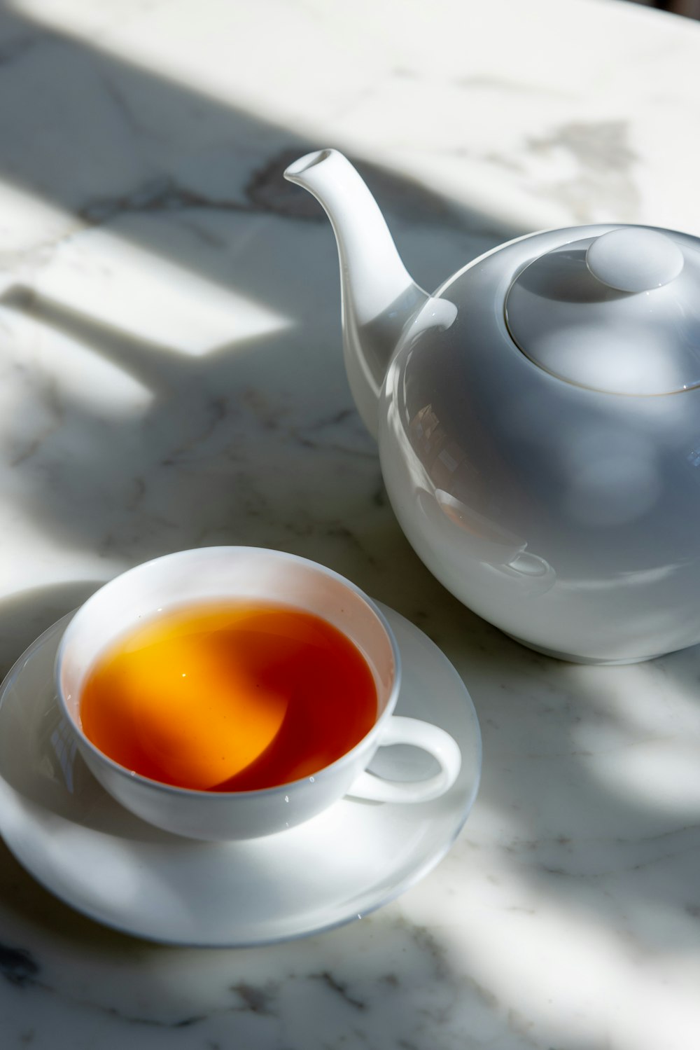 a cup of tea and a teapot on a table