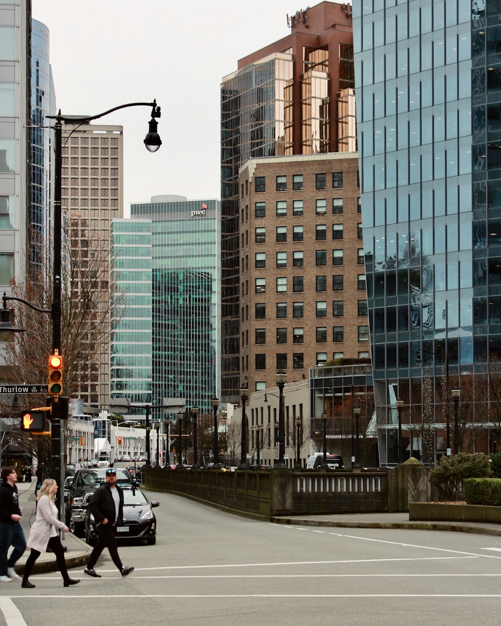 a group of people crossing a street in a city