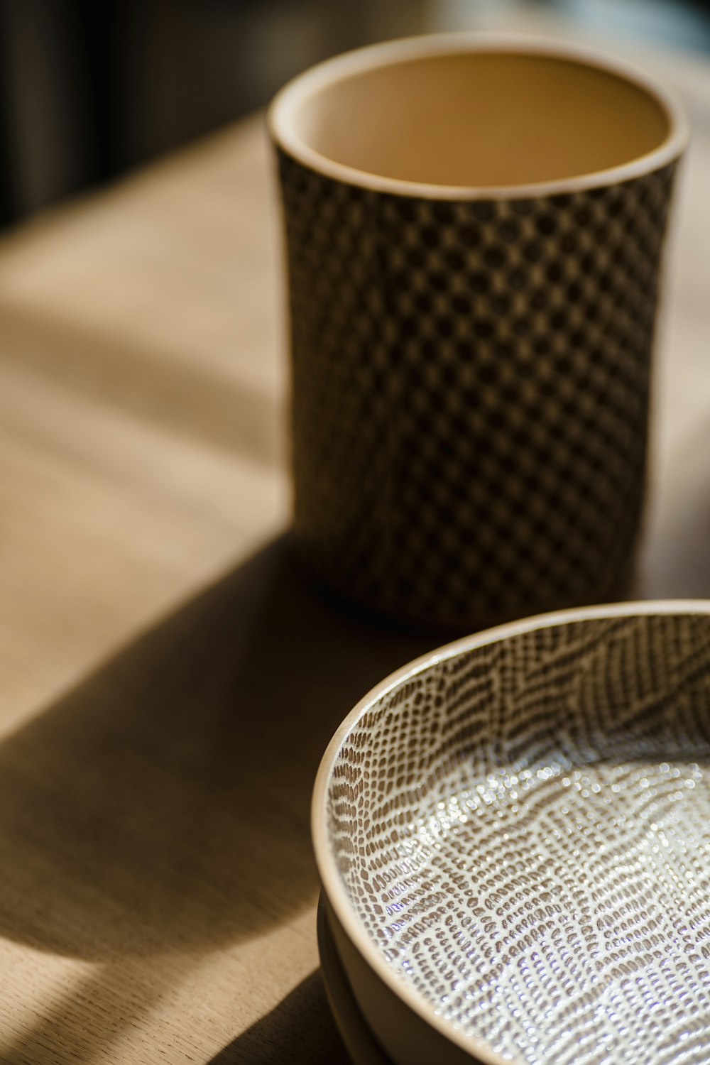 a close up of a plate and a cup on a table