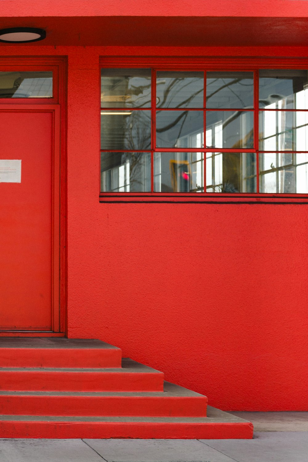 a fire hydrant sitting in front of a red building