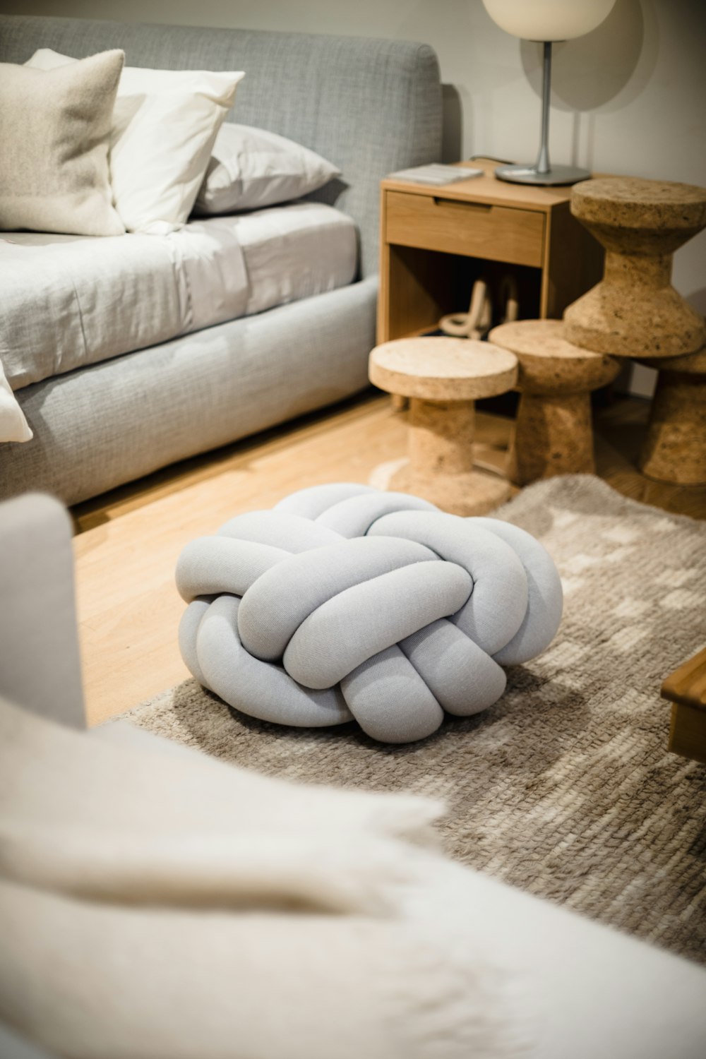 a white pillow sitting on top of a wooden floor