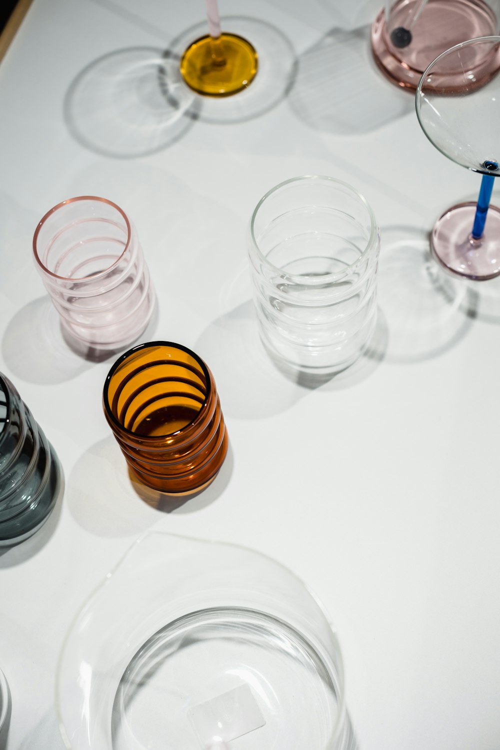 a white table topped with glasses and plates