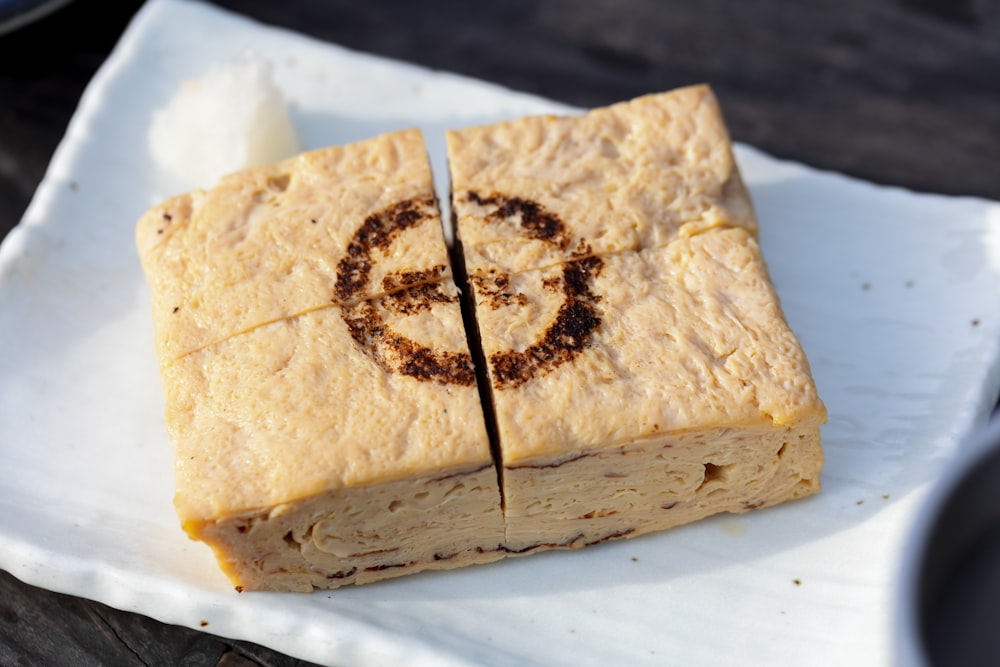 a square piece of food with a smiley face drawn on it