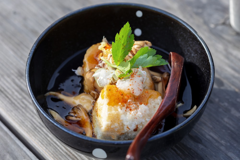 a bowl of food on a wooden table