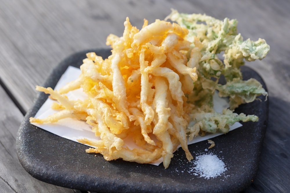 a pile of fried food sitting on top of a plate