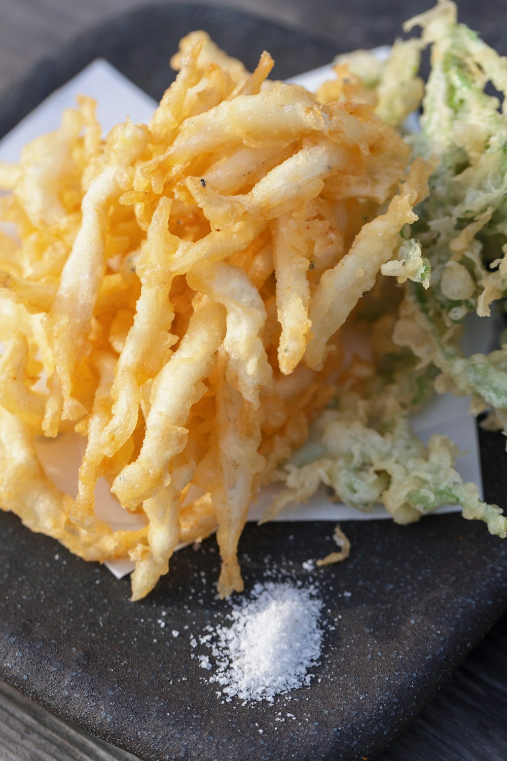 a pile of fried food sitting on top of a cutting board