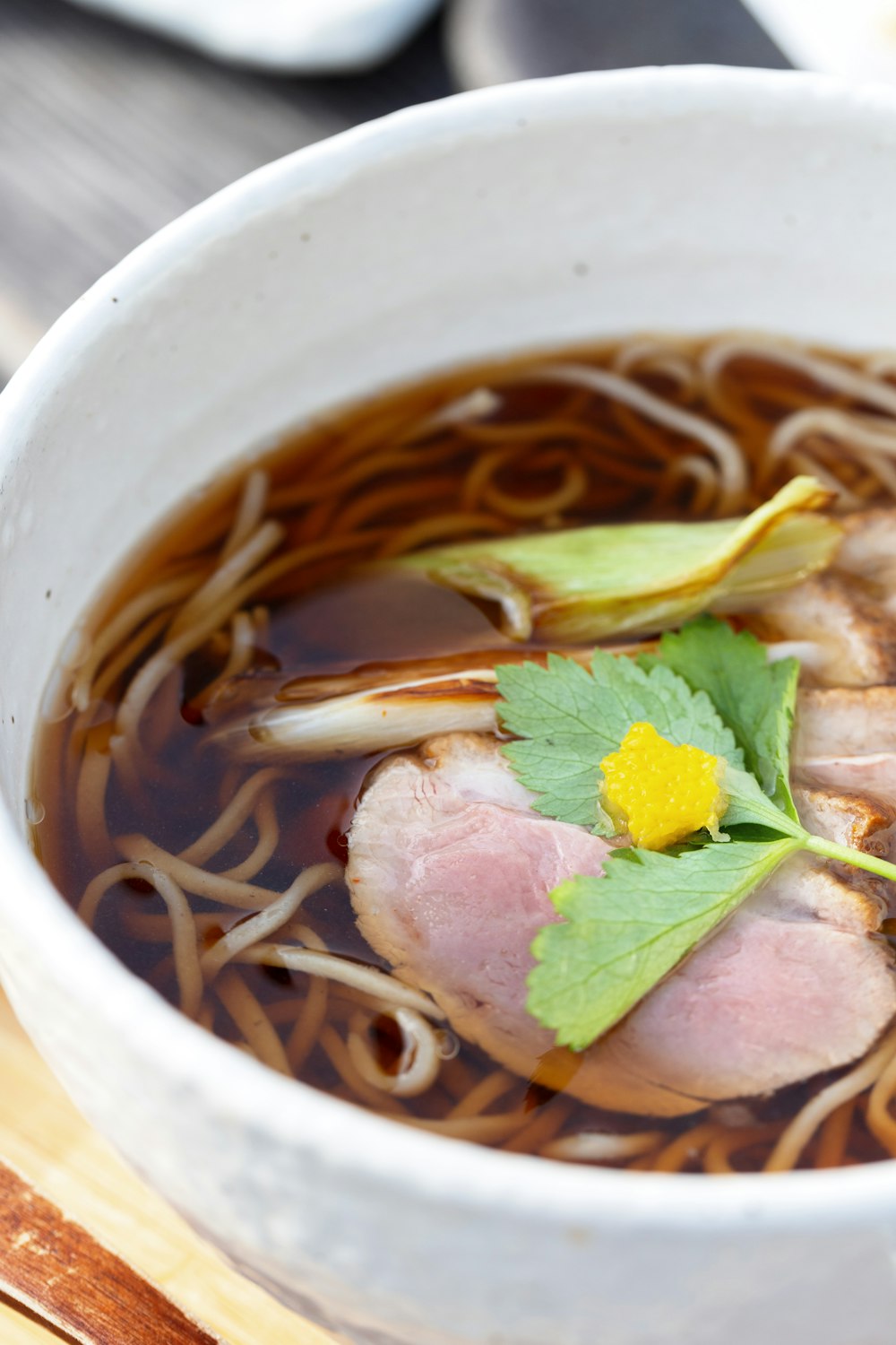 a close up of a bowl of food with noodles