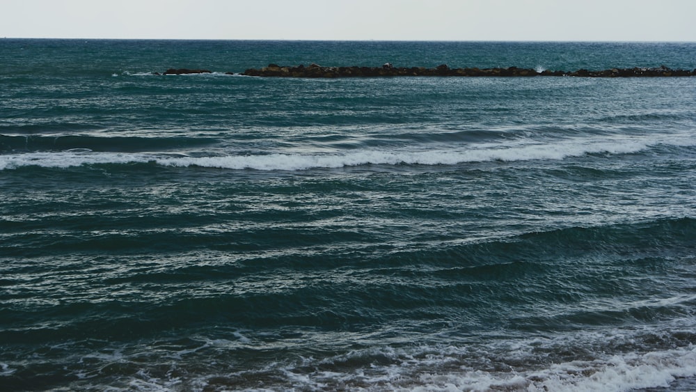 a body of water with waves coming in to shore