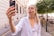 a woman taking a picture with her cell phone