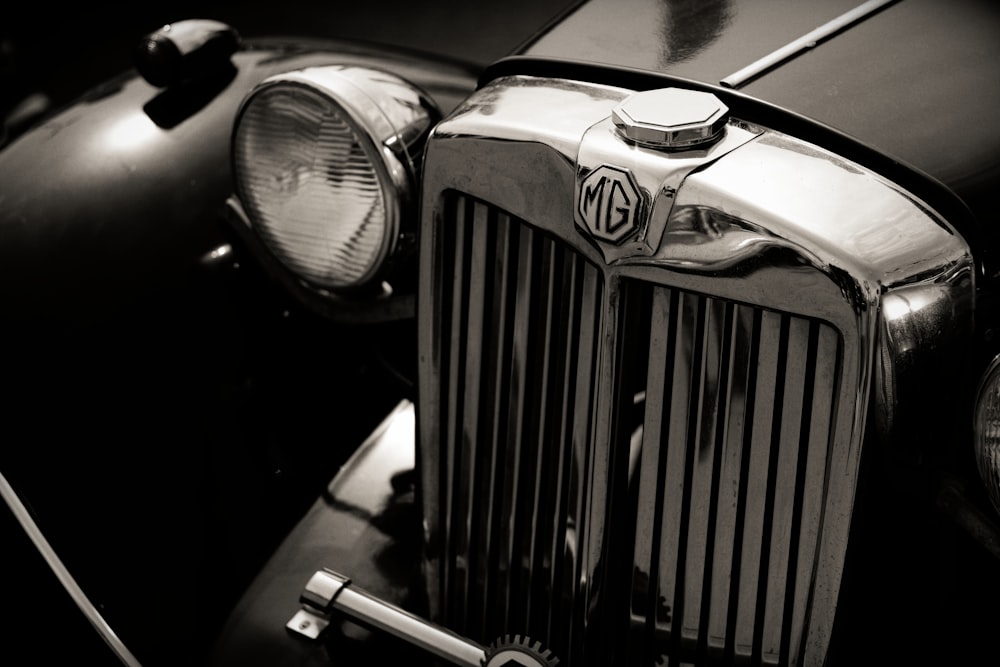 a black and white photo of a vintage car