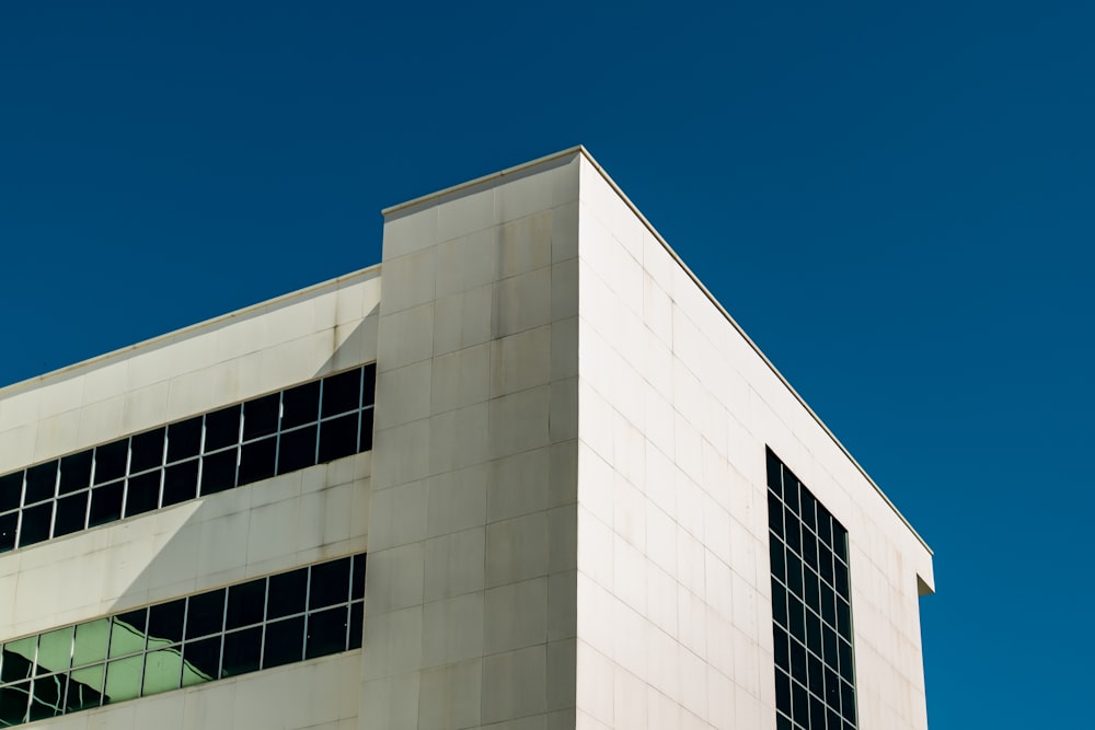 a tall white building with lots of windows