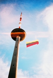 a tall tower with a flag on top of it