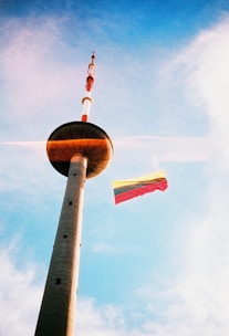 a tall tower with a flag on top of it