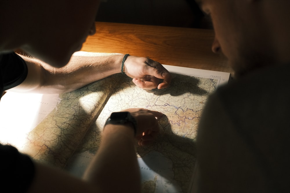 two people looking at a map on a table