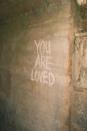 you are loved written on the side of a wall