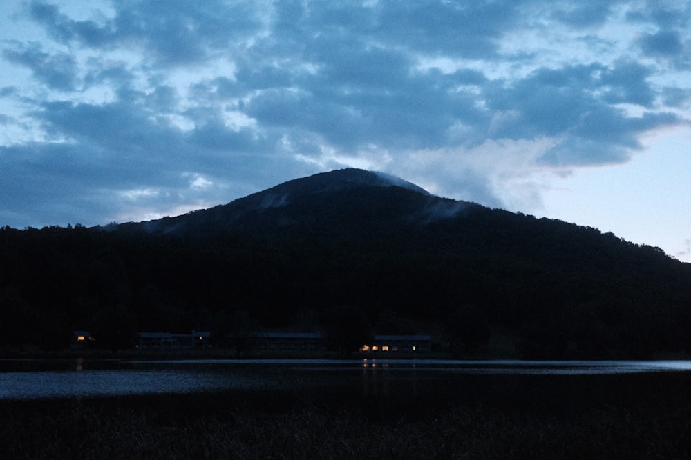 a mountain with a body of water in front of it