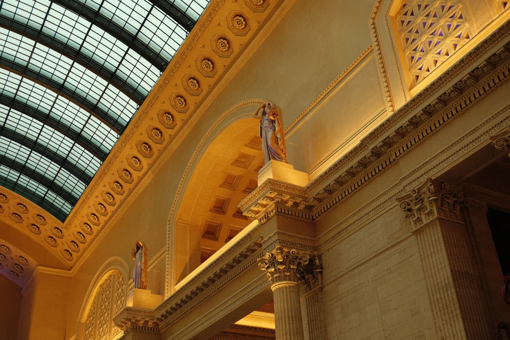 a large building with a glass ceiling and a statue