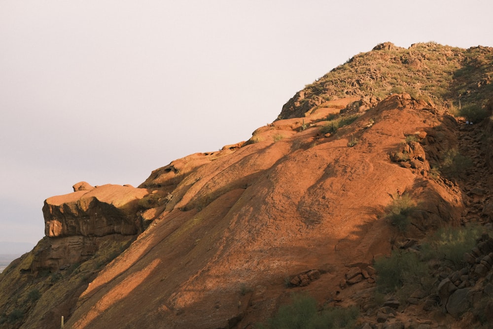 a mountain with a large rock formation on top of it