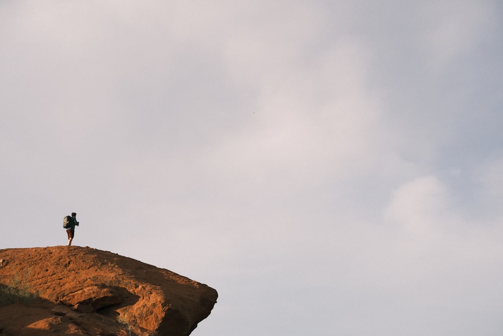 a person standing on top of a cliff