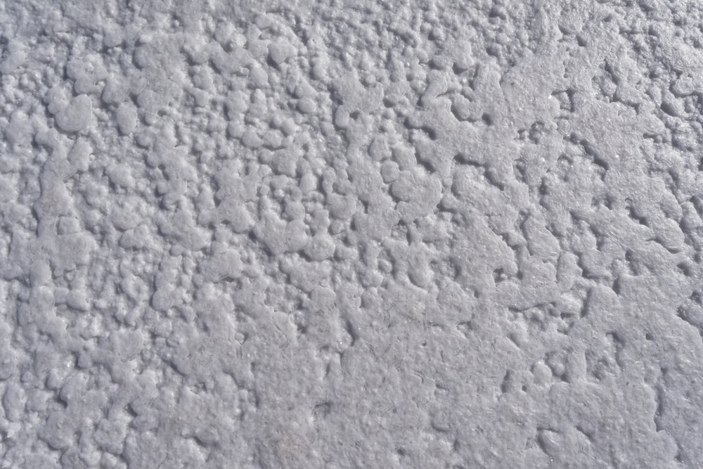 a close up of a white surface with small dots