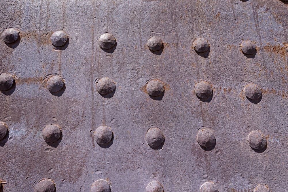 a close up of a metal surface with rivets