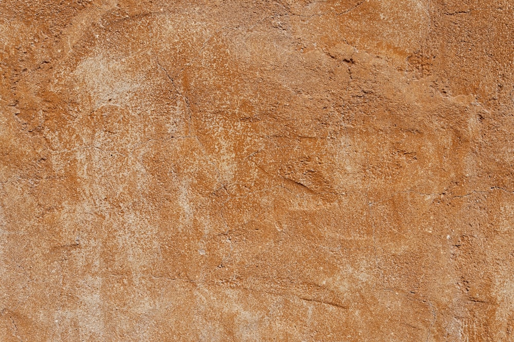 a brown stucco wall with a white clock on it