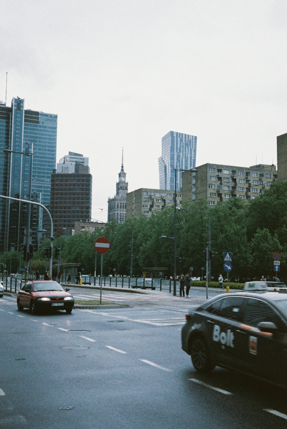 a police car driving down a street next to tall buildings