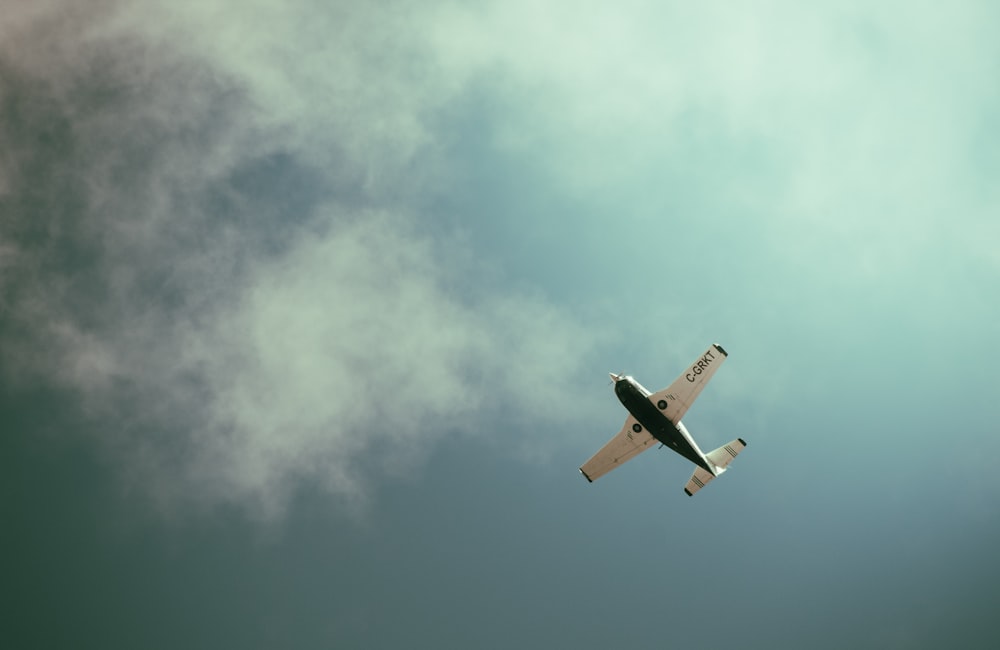 an airplane is flying in the sky with clouds