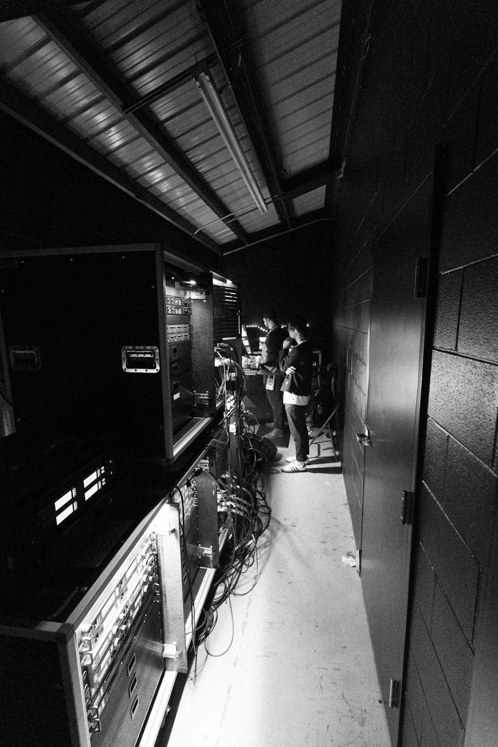 a black and white photo of a group of people in a room