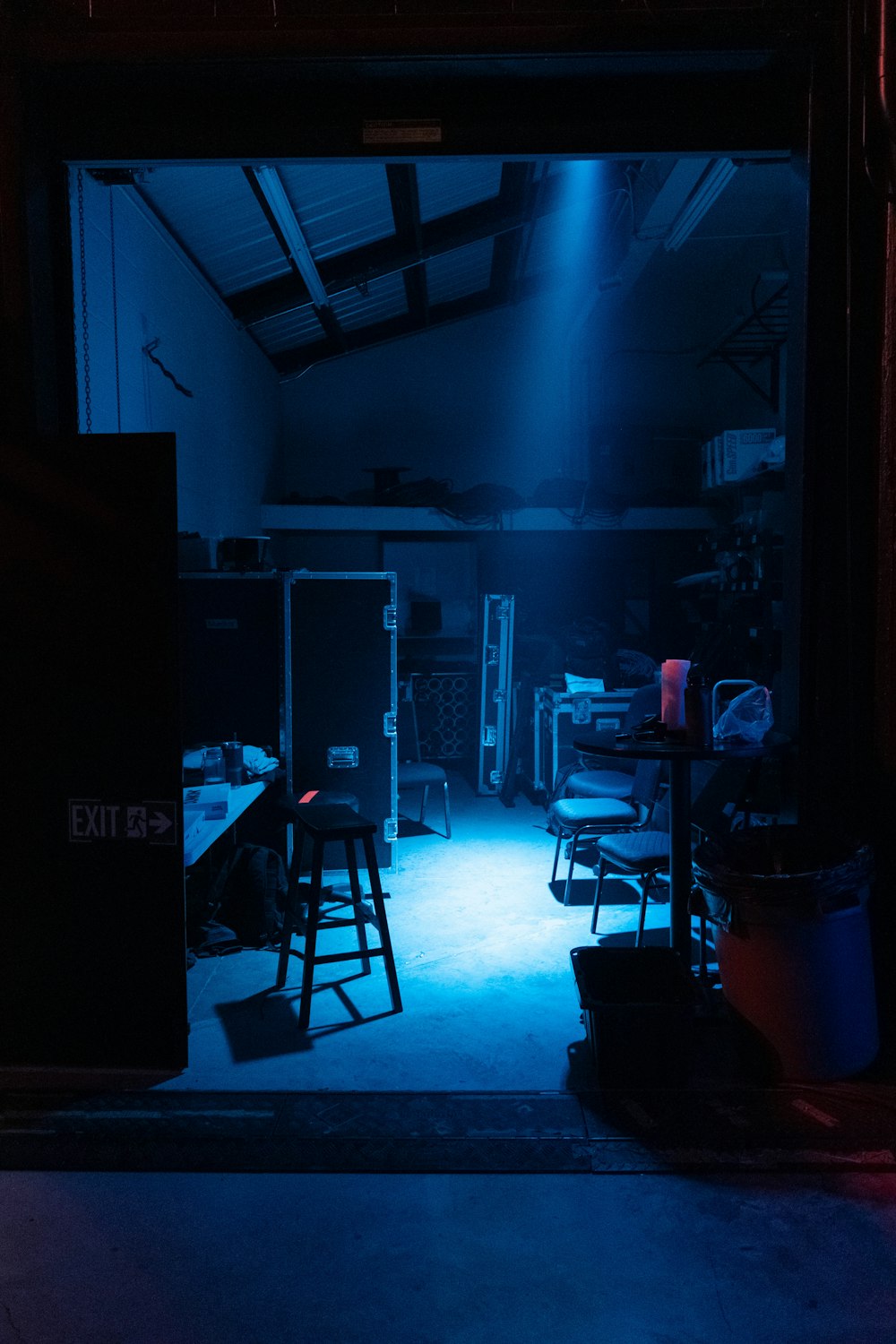 a dark room with two chairs and a table