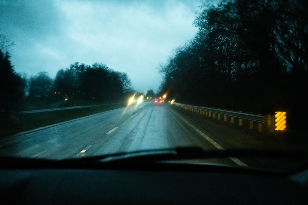 a car driving down a road at night