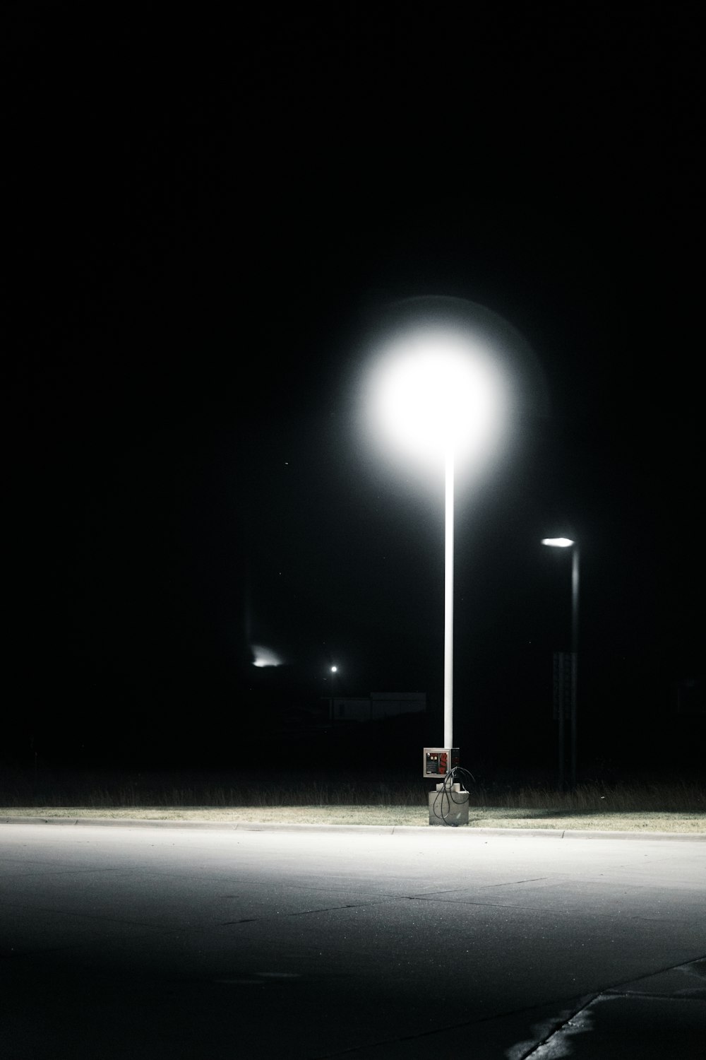 an empty parking lot at night with a street light