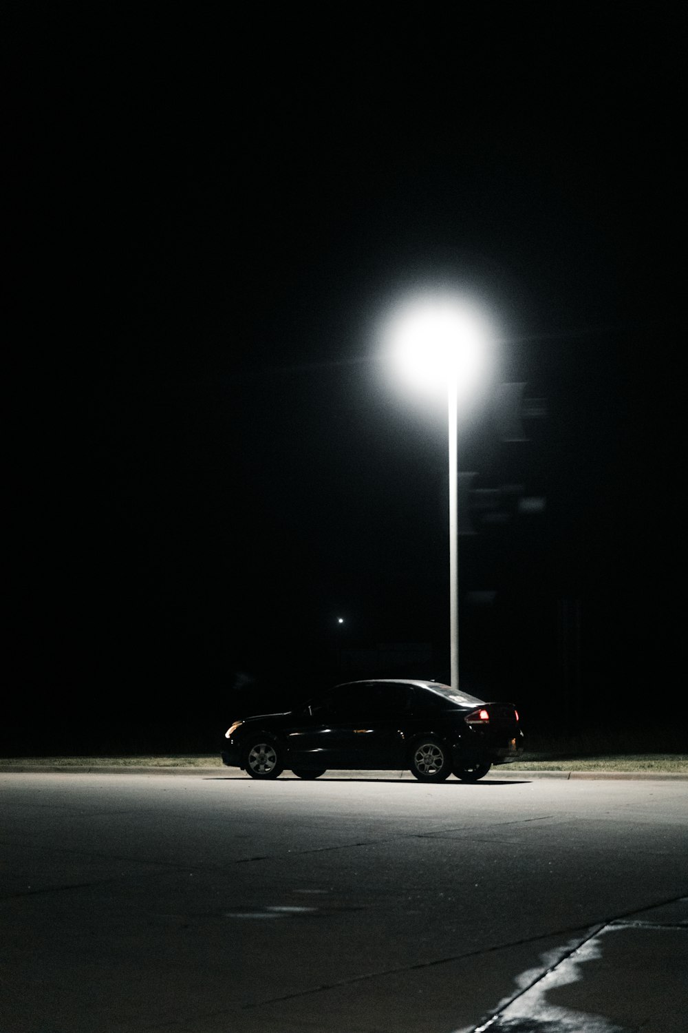 a car parked in a parking lot at night