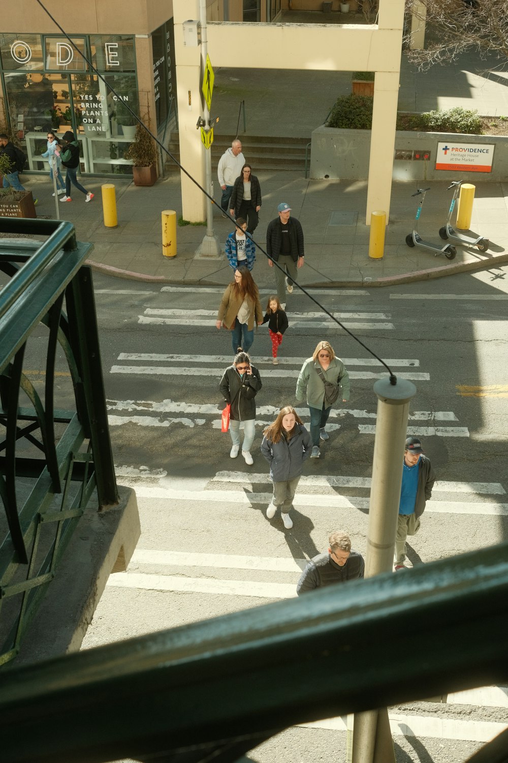 a group of people walking across a street