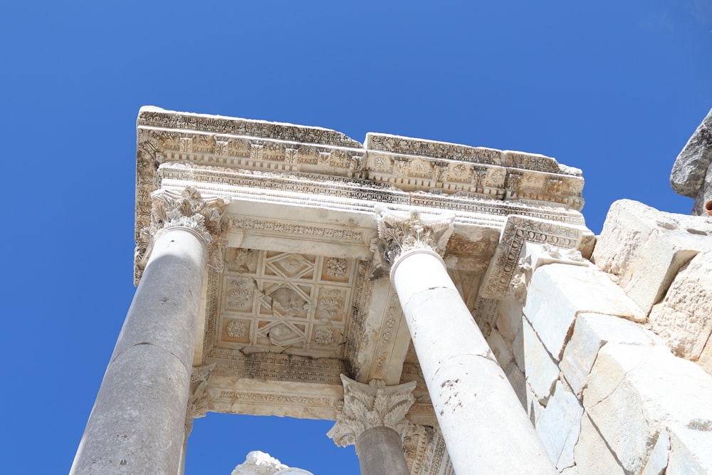 a close up of the top of a building with columns