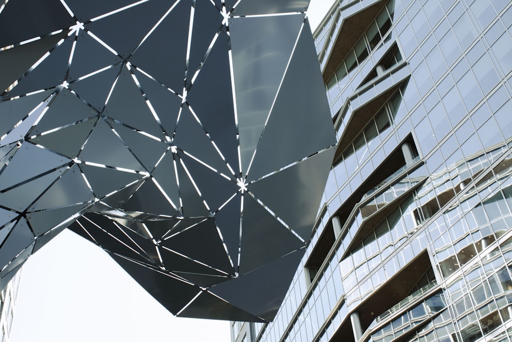 a sculpture in front of a tall building