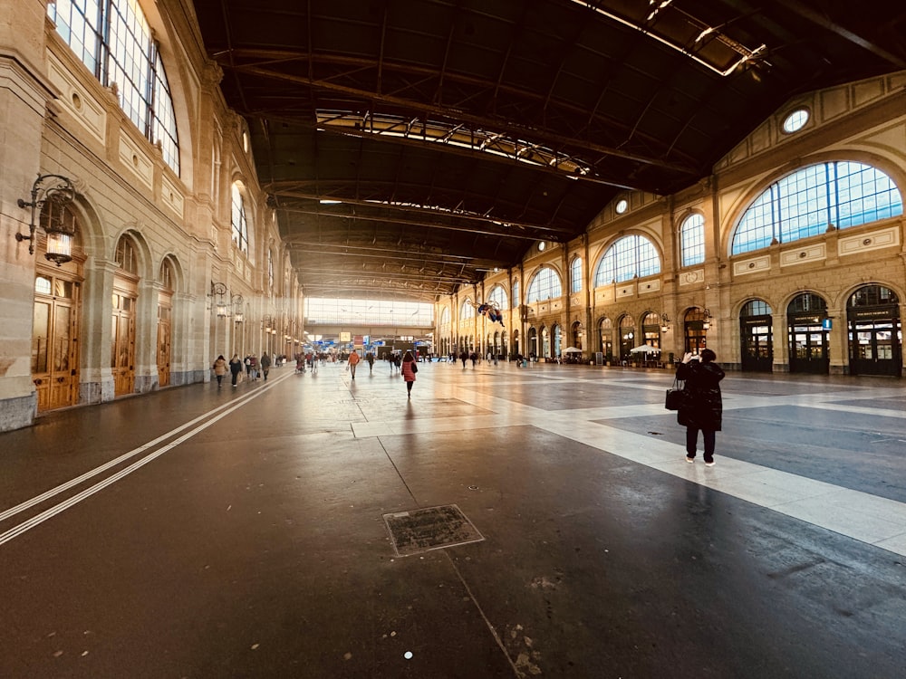 a person is walking in an empty train station