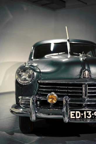an old car with a sign on the front of it