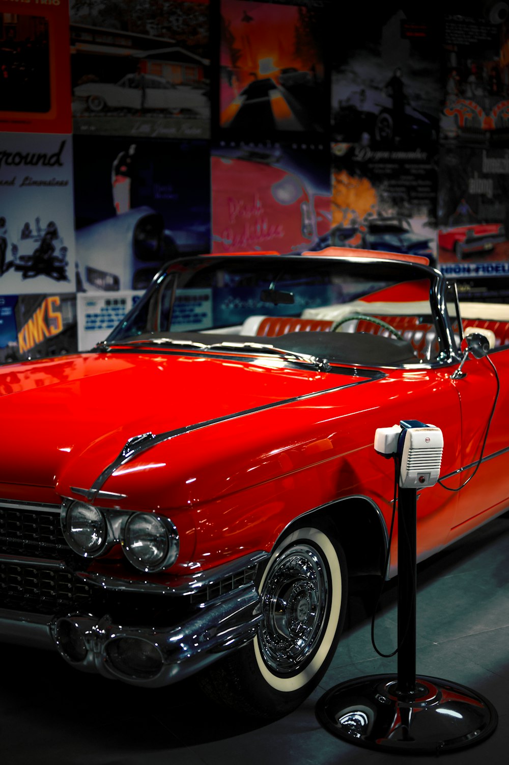 a red car parked in a garage next to other cars