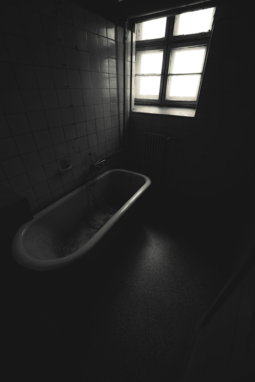 a bath tub sitting in a bathroom next to a window