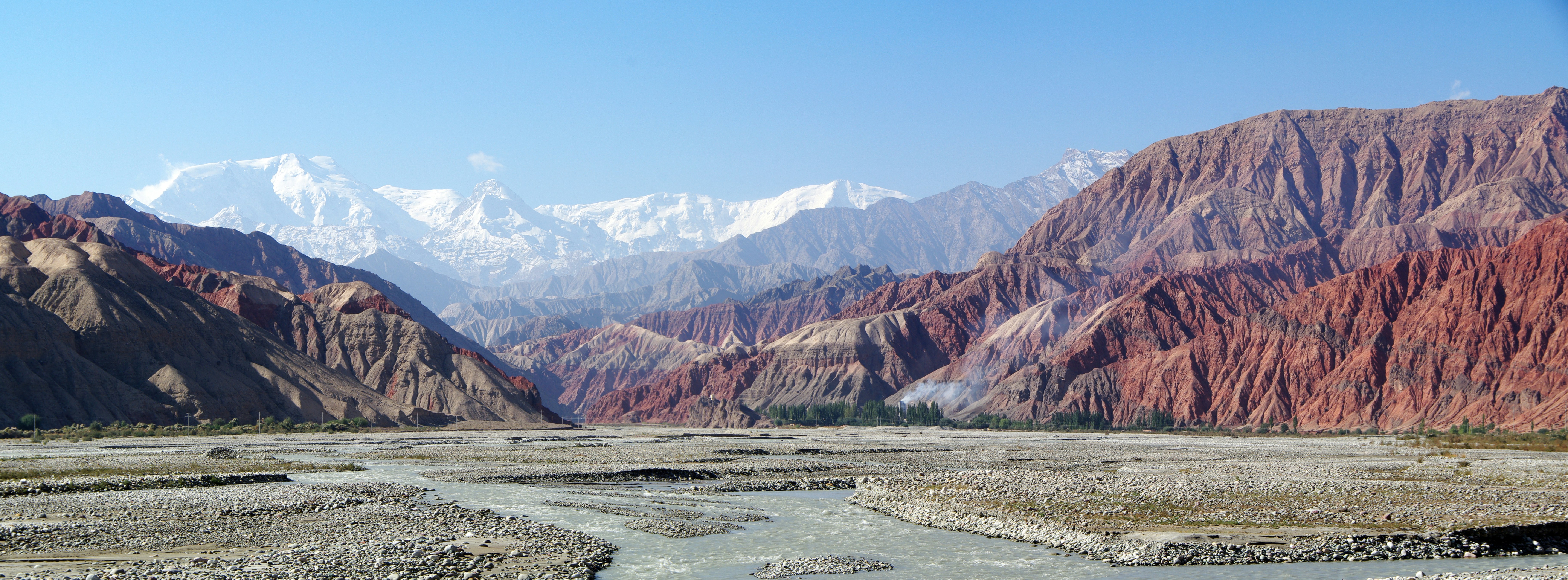 a river running through a valley surrounded by mountains