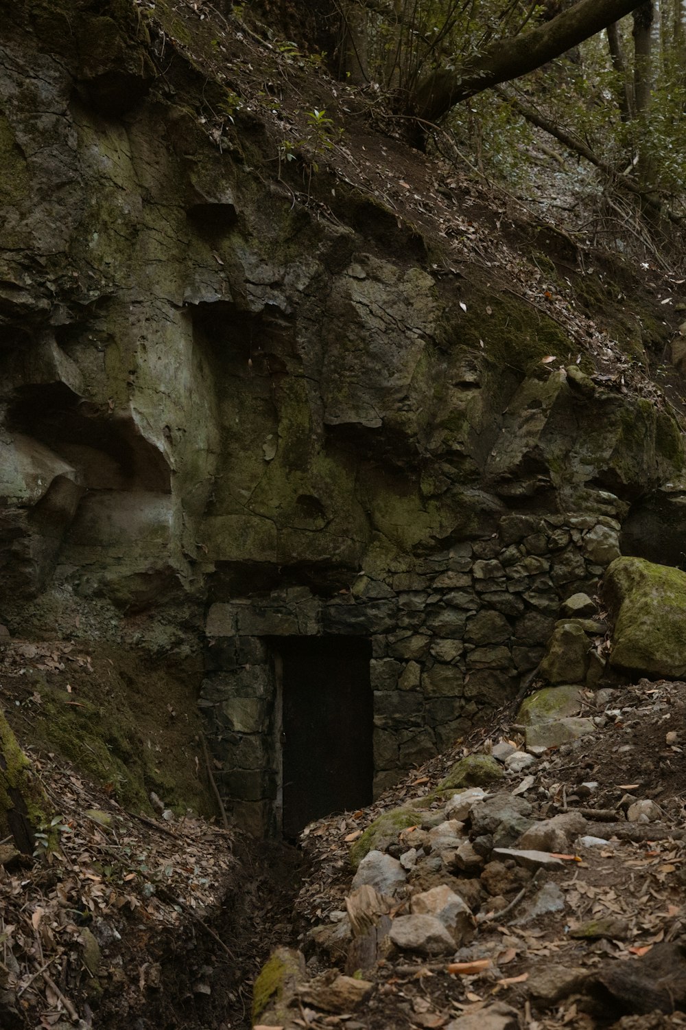 a small cave in the side of a mountain