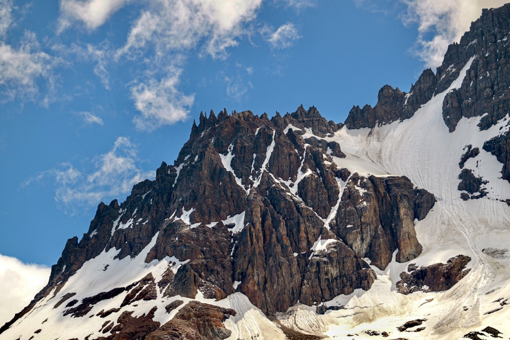 a snow covered mountain under a blue sky