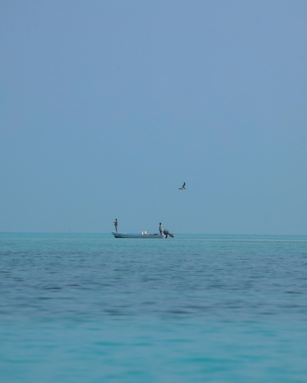 a small boat in the middle of a large body of water