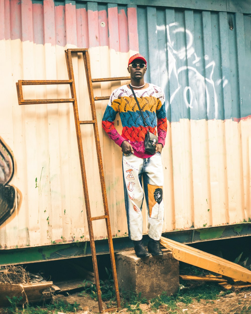 a man standing in front of a building with a ladder