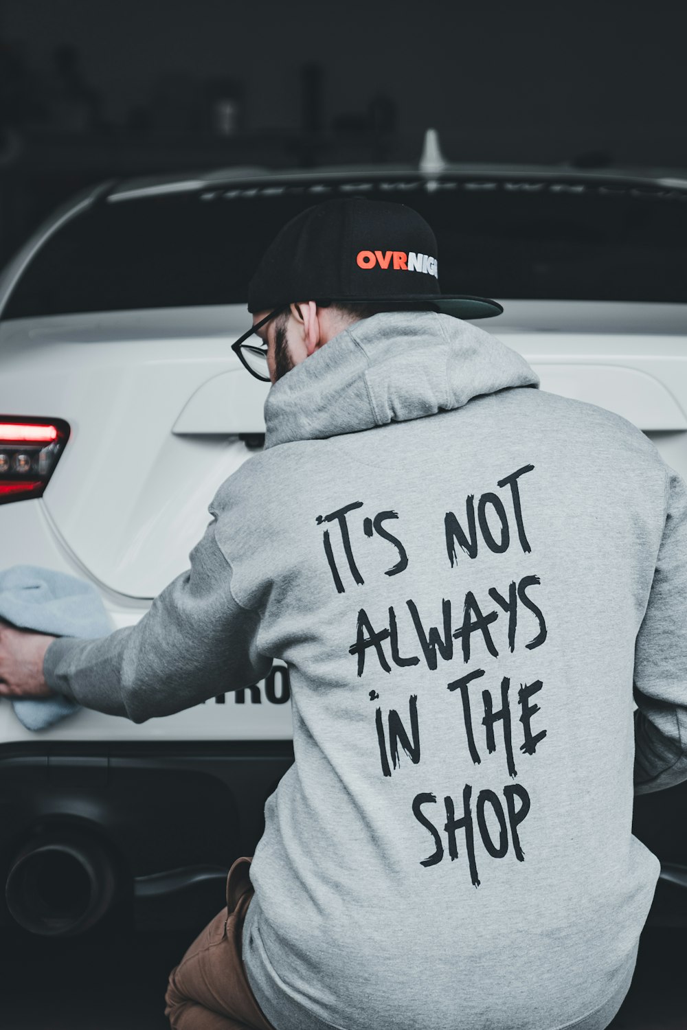 a man sitting on the hood of a car