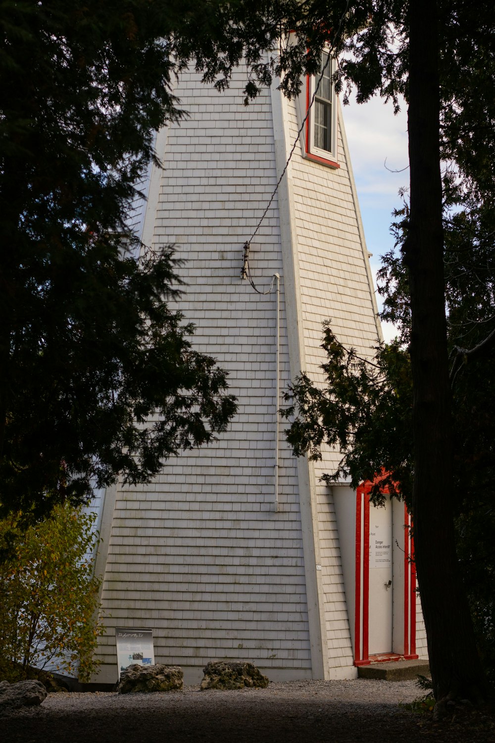 a tall white tower with a clock on it's side