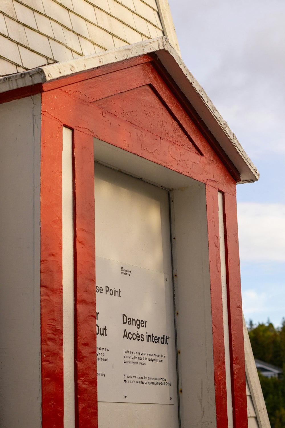 a red and white building with a sign on it