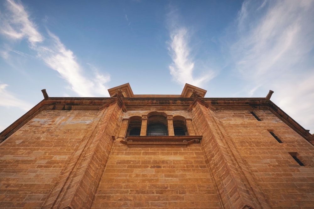 a tall brick building with a sky background